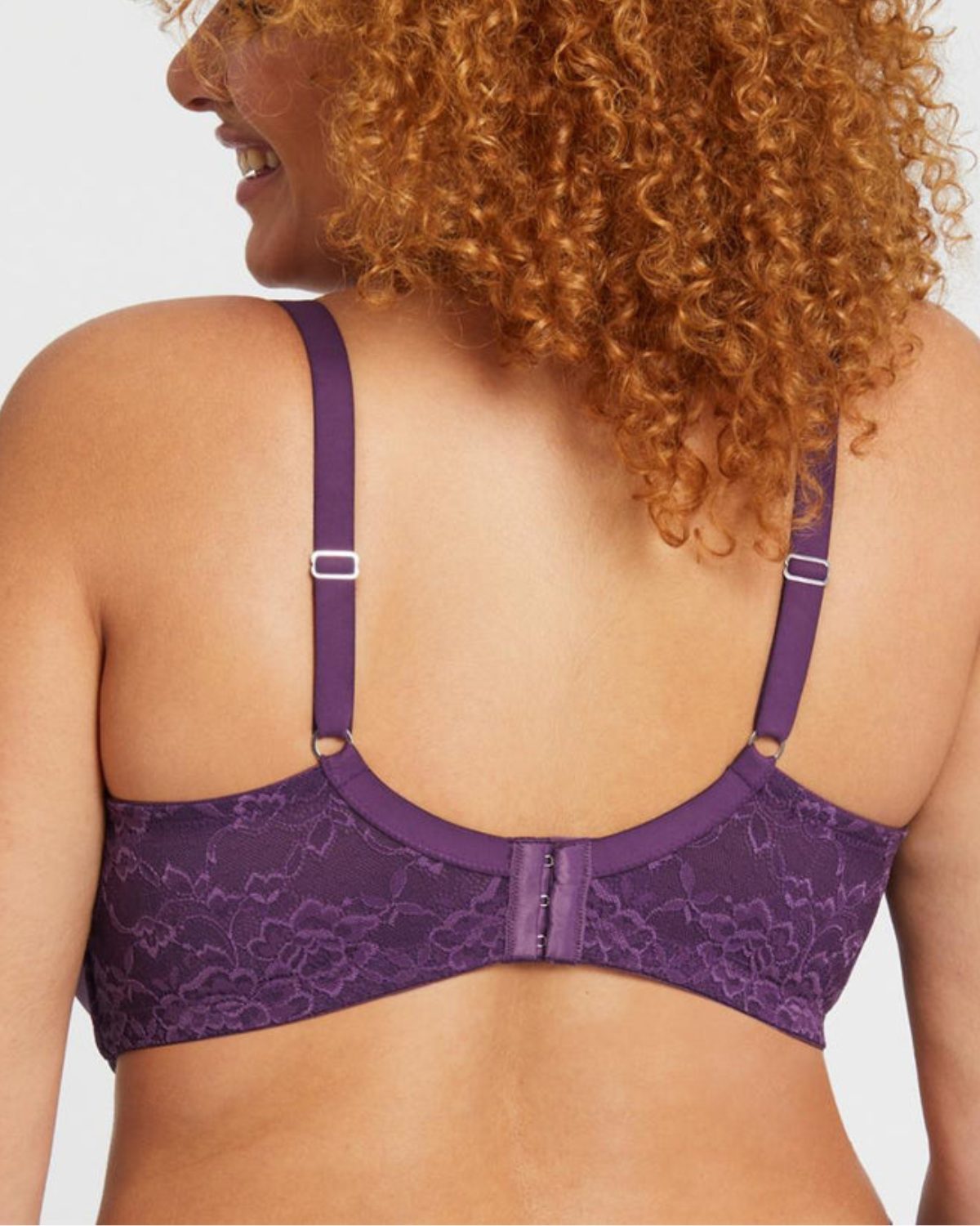 Model wearing a wire free molded cup bra with lace wings in purple
