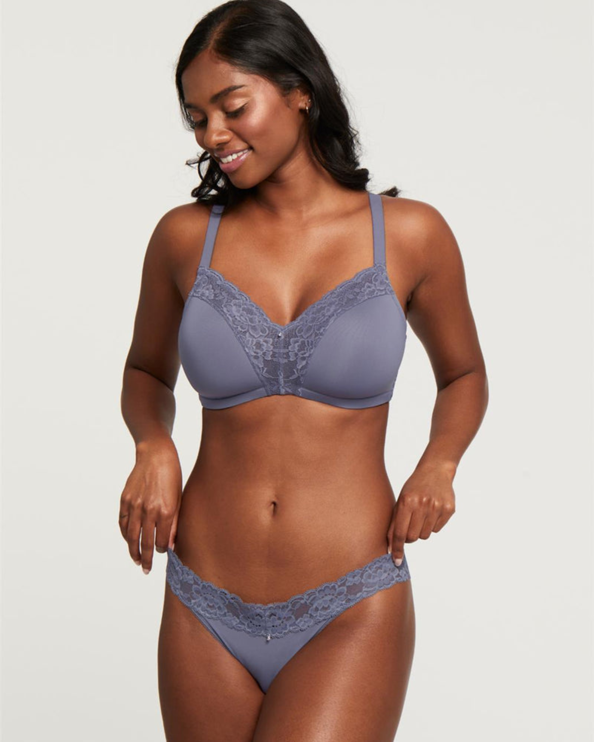 Model wearing a wire free molded cup bra with lace wings in grey