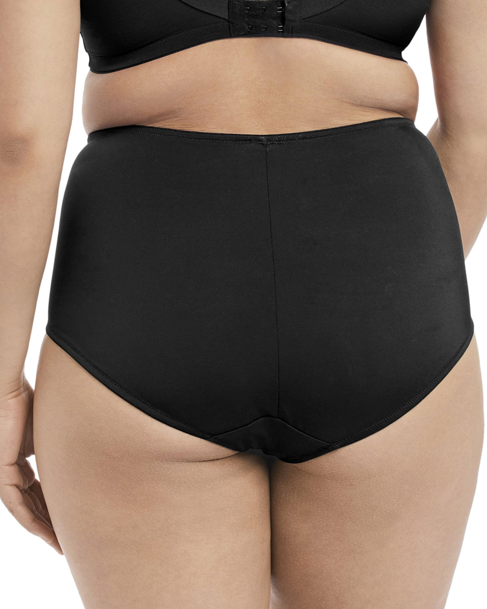 Model wearing a high waist full brief panty with mesh inserts in black