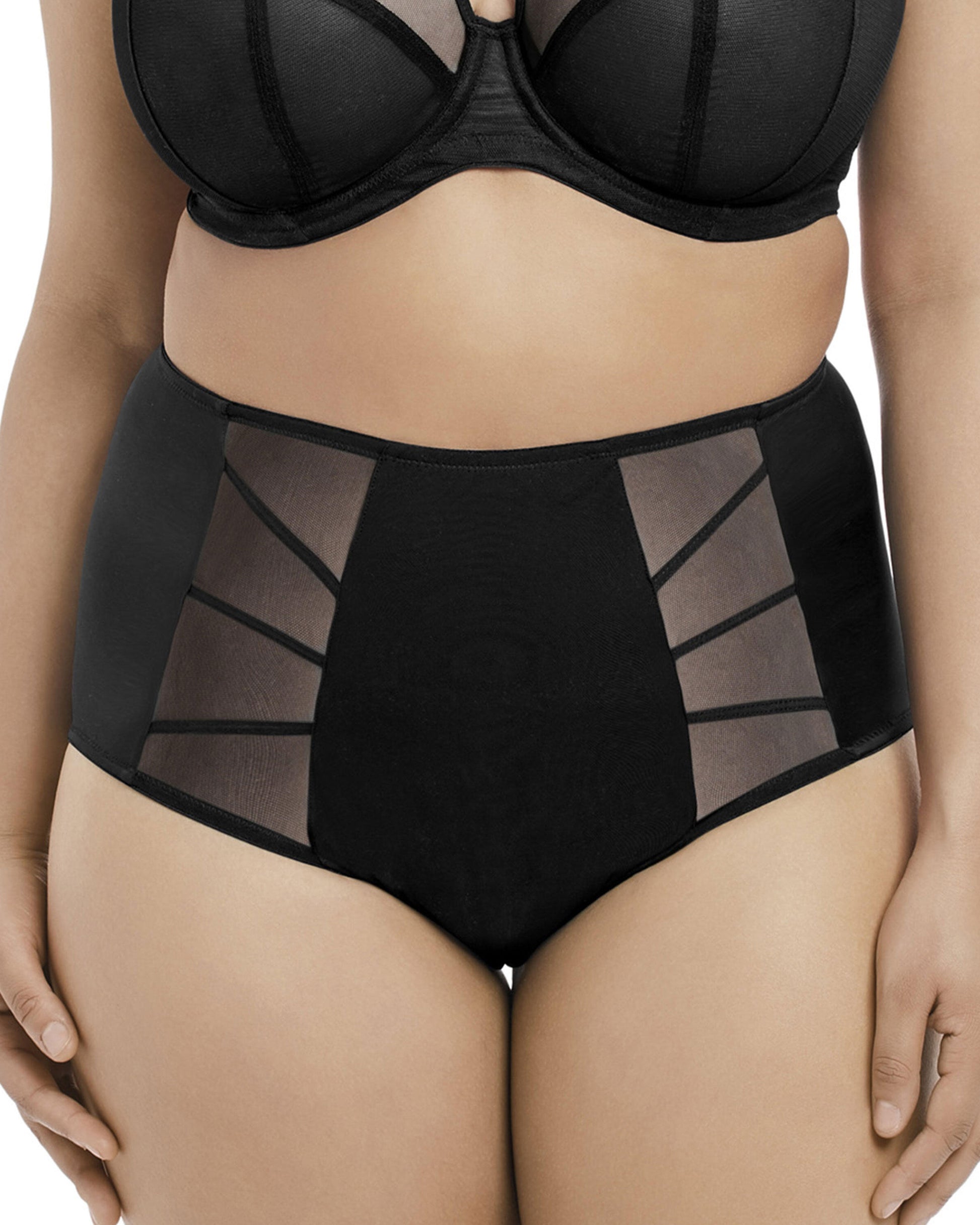 Model wearing a high waist full brief panty with mesh inserts in black