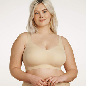 A close up of a woman wearing a beige wire free bra.