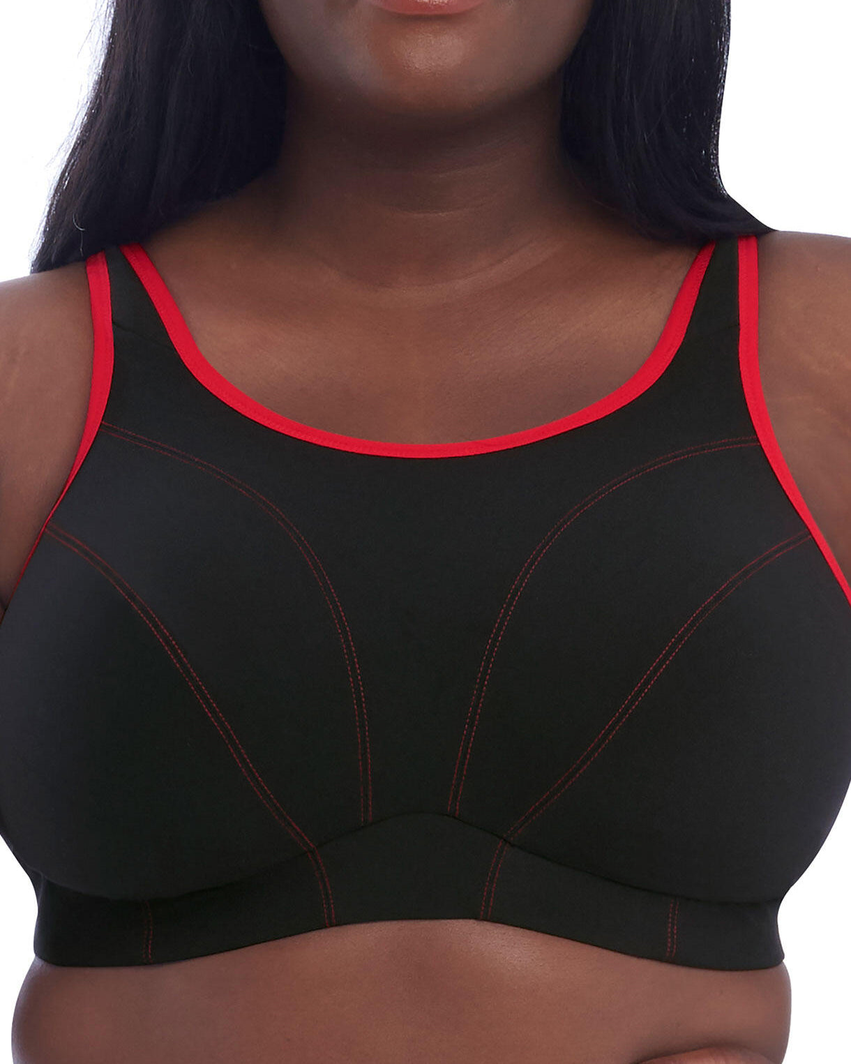 Model wearing a wire free sports bra in black with a red trim