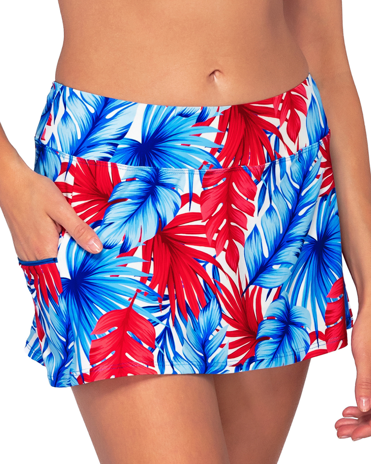 Model wearing a swim skirt with a side pocket and hidden shorts in a red, white and blue palm front print.