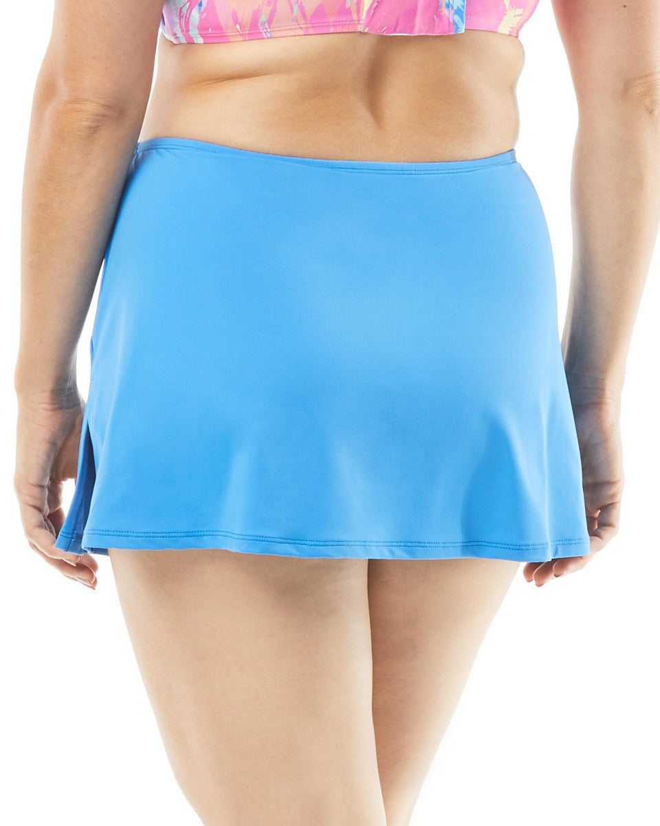 Bottom half the backside of a model on white background in a light blue swim skirt with a slit