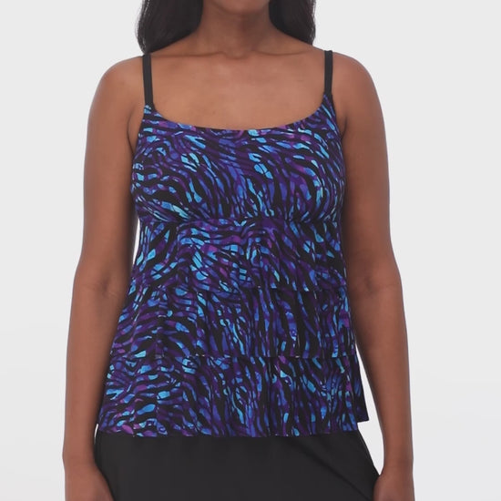 Model turning 360 degrees wearing a faux skirtini with a black skirted bottom and black, purple and blue animal print top.