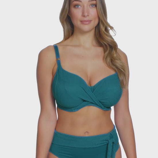 Model turning 360 degrees in an underwire wrap bikini top in blue
