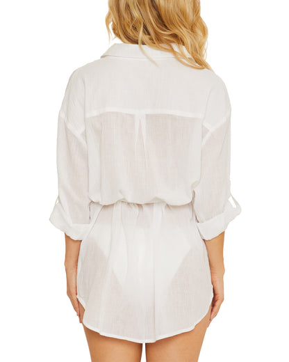 Model wearing a gauzy button up shirt dress in white
