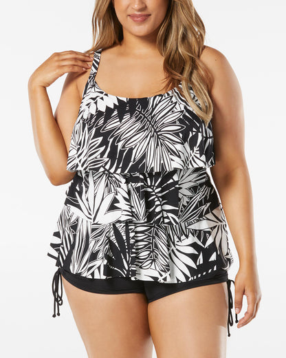 Model wearing a plus sized triple tiered tankini top in a black and white abstract palm frond print