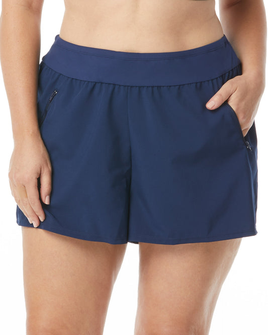 Model wearing a banded swim short with a zipper pocket in navy